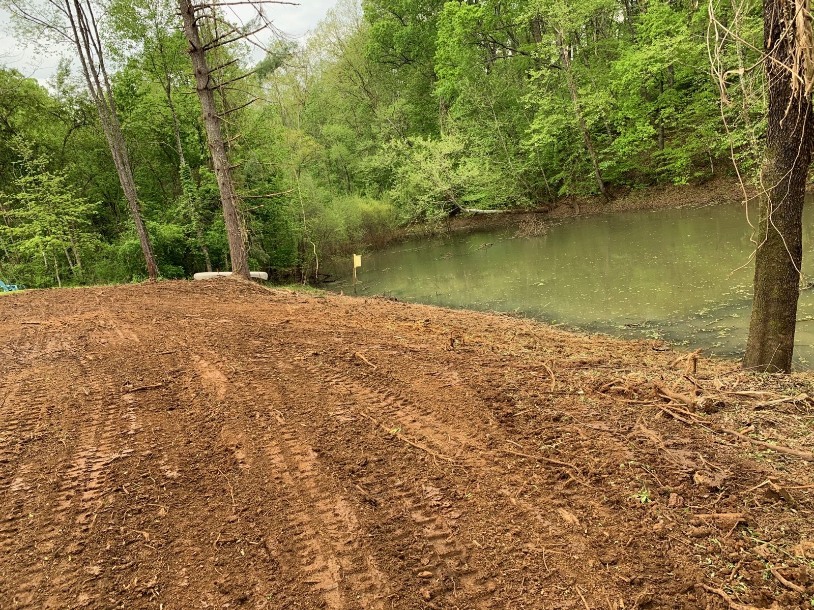 Cleared and graded lot beside a calm river