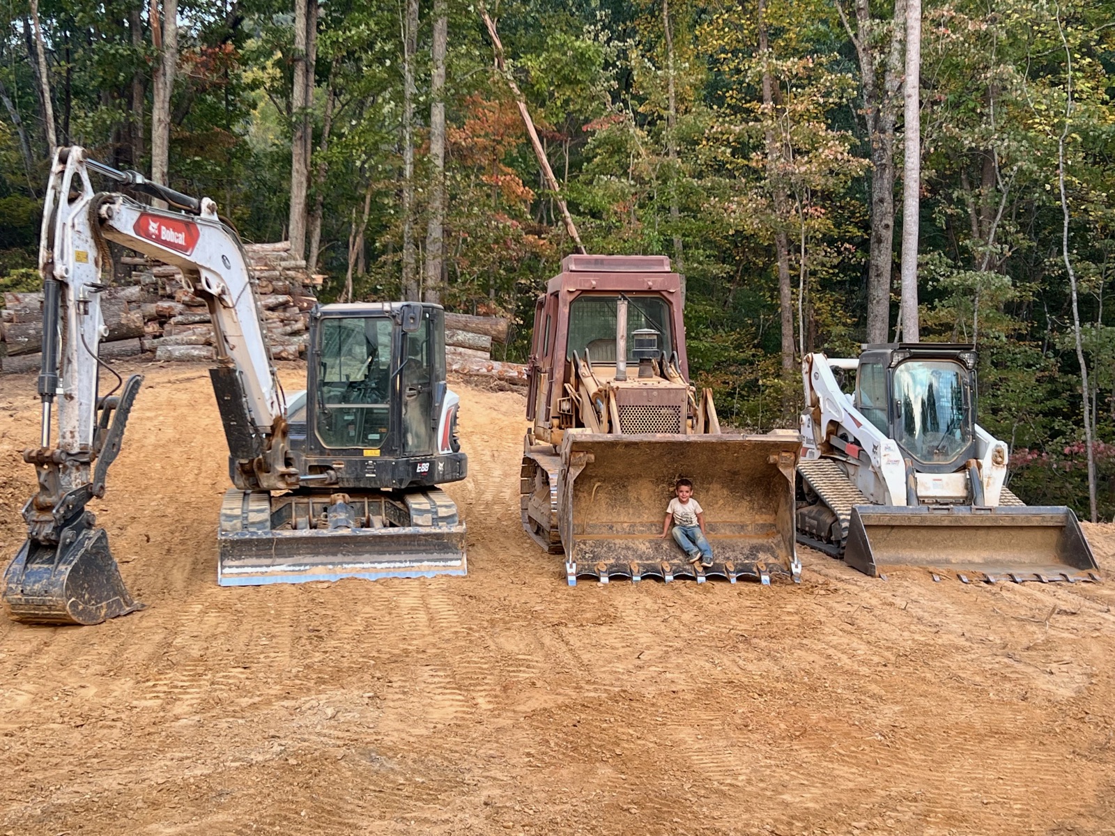 Bobcat excavator, dozer, and skid steer staged on a finished site