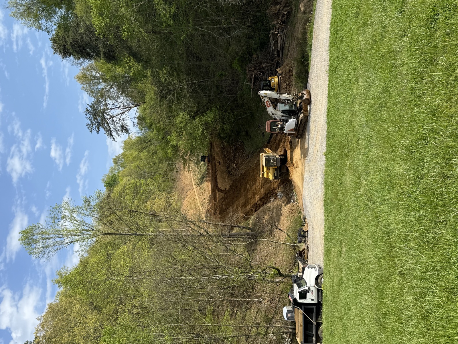 Equipment moving dirt at a residential site