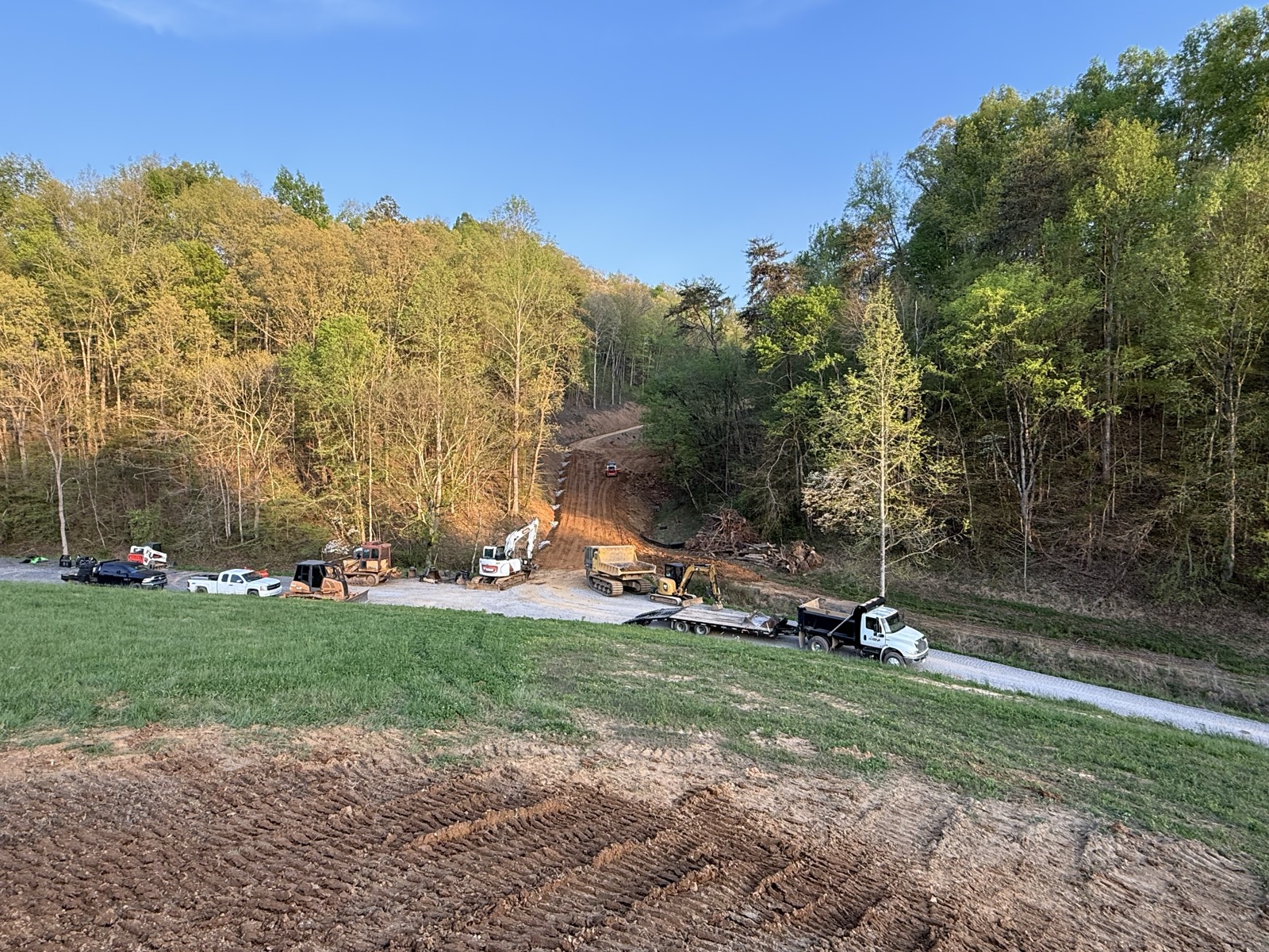 Driveway base prep with dump truck on site
